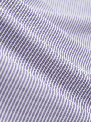 Close-up texture of light purple white comfy breathable pin-stripe texture golf polos fabric showing weave detail.