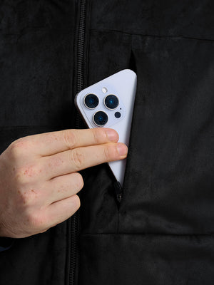 Close-up view of black classic micro suede leather puffer vest exterior center pocket detail