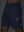 Detail of glow in the dark feature on navy 4 way stretch breathable workout athletic shorts