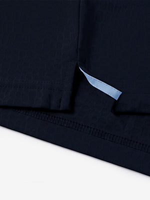 Hem detail close-up in navy of nylon blend casual jacquard polo shirts.