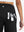Back side view of pocket on black women's high waist 2 in 1 quick dry shorts with 7 pockets
