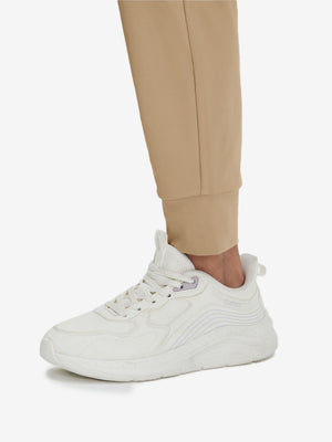 Detail view of hem on light khaki women's lightweight athletic sweatpants
