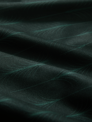Close-up texture of green palm leaves stylish full print contrast collared golf polo shirts fabric showing weave detail.