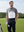Model in white premium performance polo holding a golf club outdoors, half-body shot